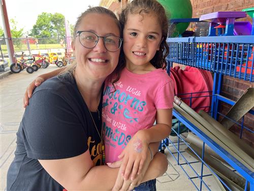 Teacher hugging child at PreK